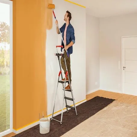 Expert painter applying fresh coat of paint